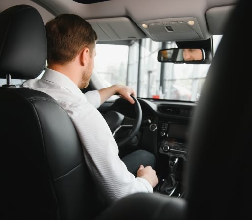 Portrait of a handsome male chauffeur sitting in a car